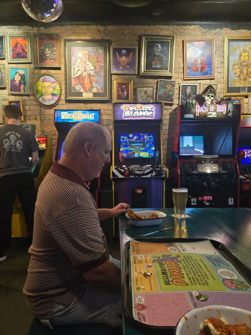 A participant enjoying a games arcade outing