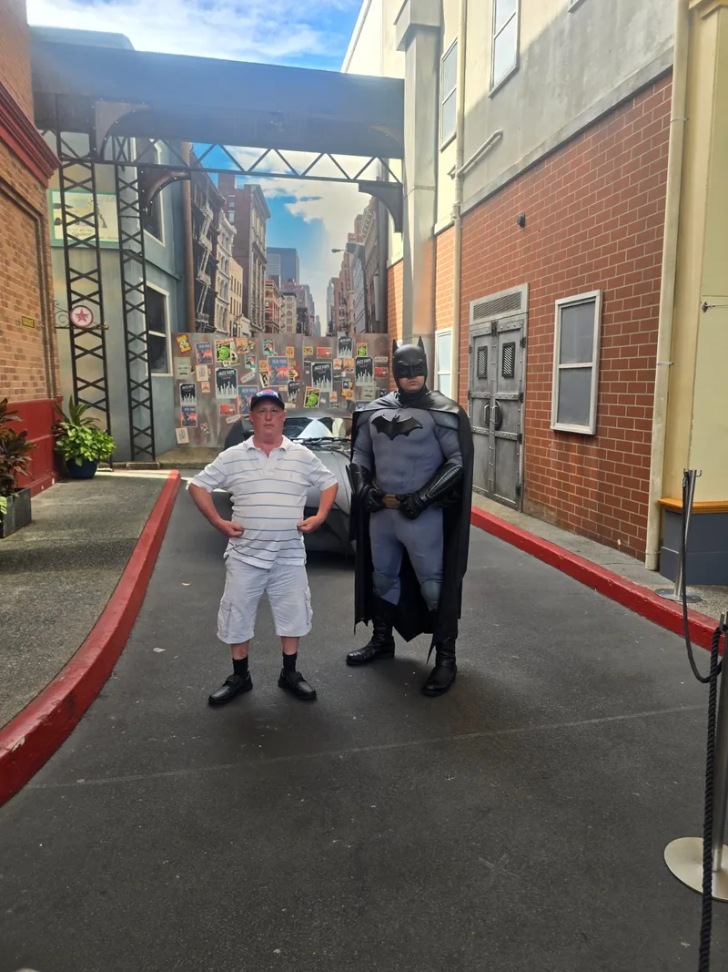 A participant meeting Batman at a theme park