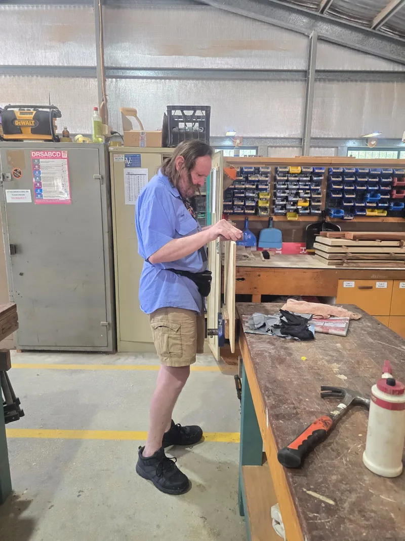 A participant working on a model at the Men's Shed