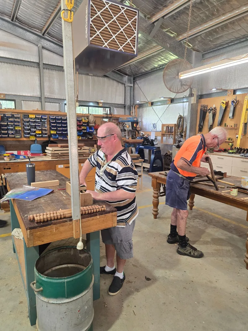 Two participants working together at the Men's Shed